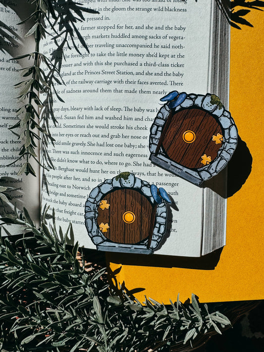 Decorative fairy doors on an open book with a yellow background
