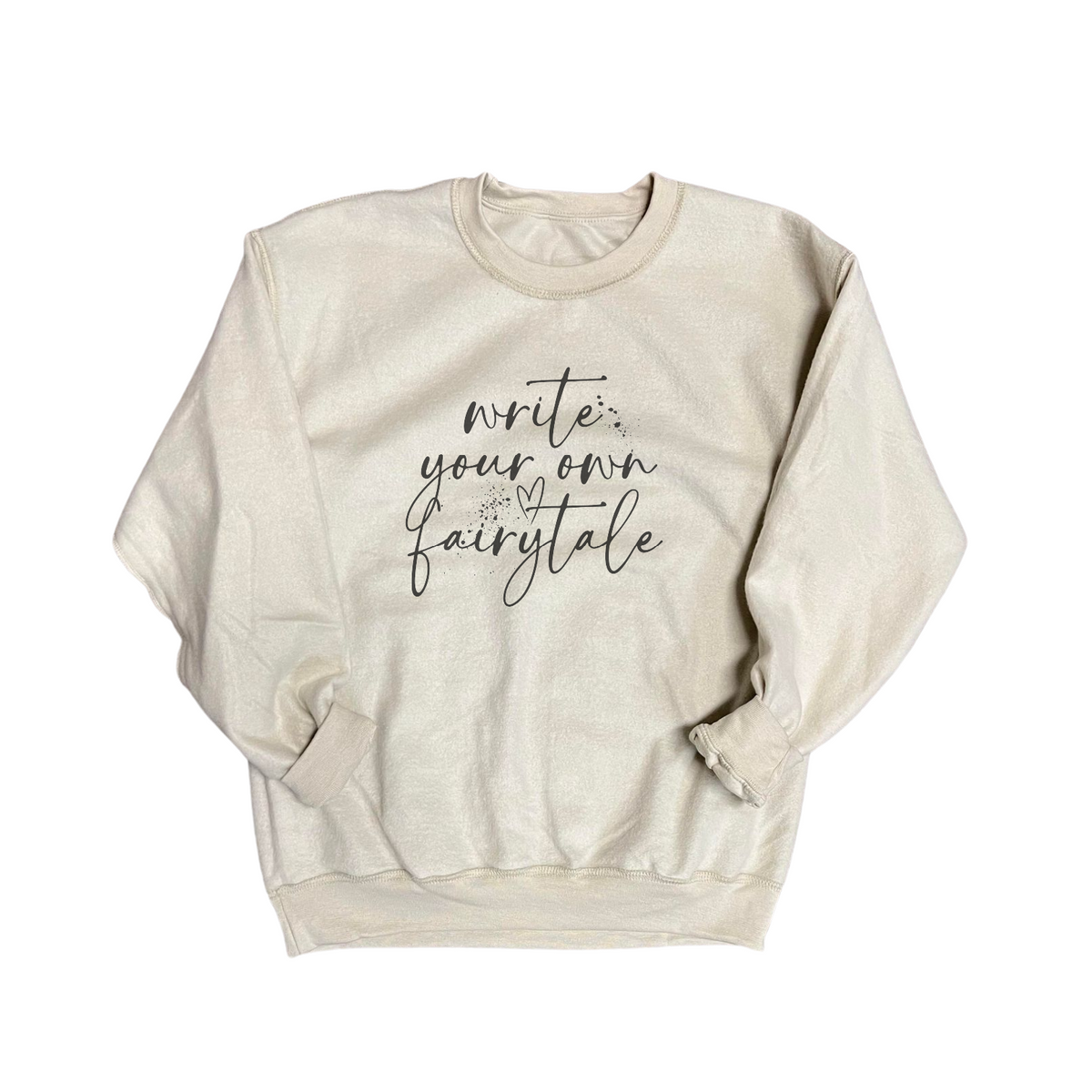 Beige sweatshirt with 'Write Your Own Fairytale' text on a white background