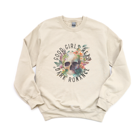 Beige sweatshirt with skull and floral design and text 'Good Girls Read Dark Romance' on a white background