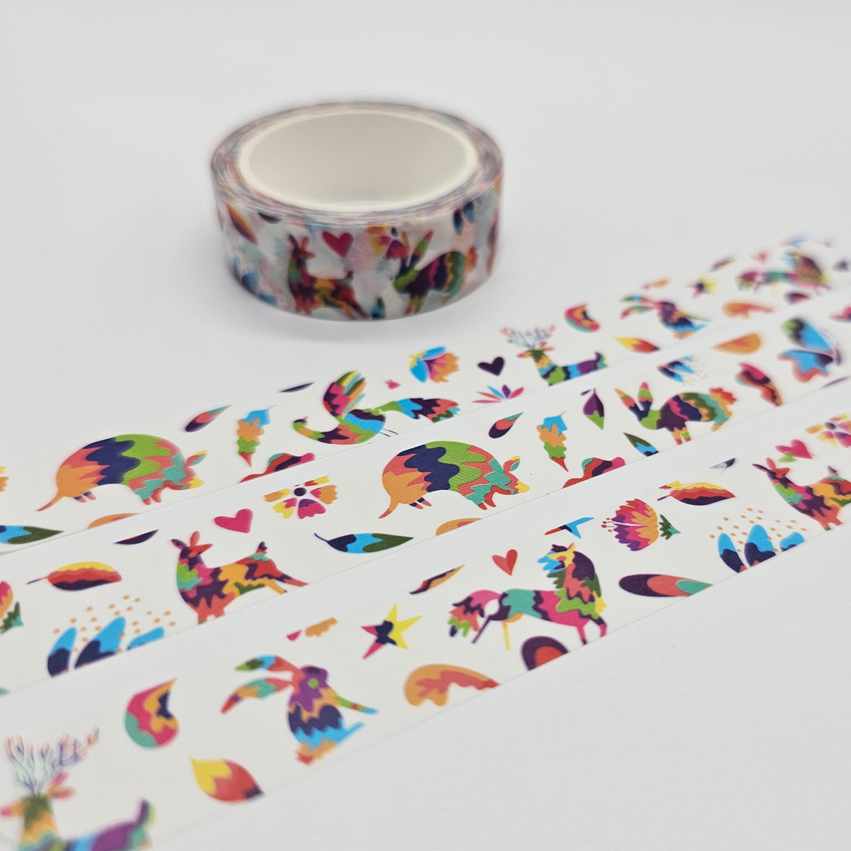 Colorful washi tape with animal and nature patterns on a white background