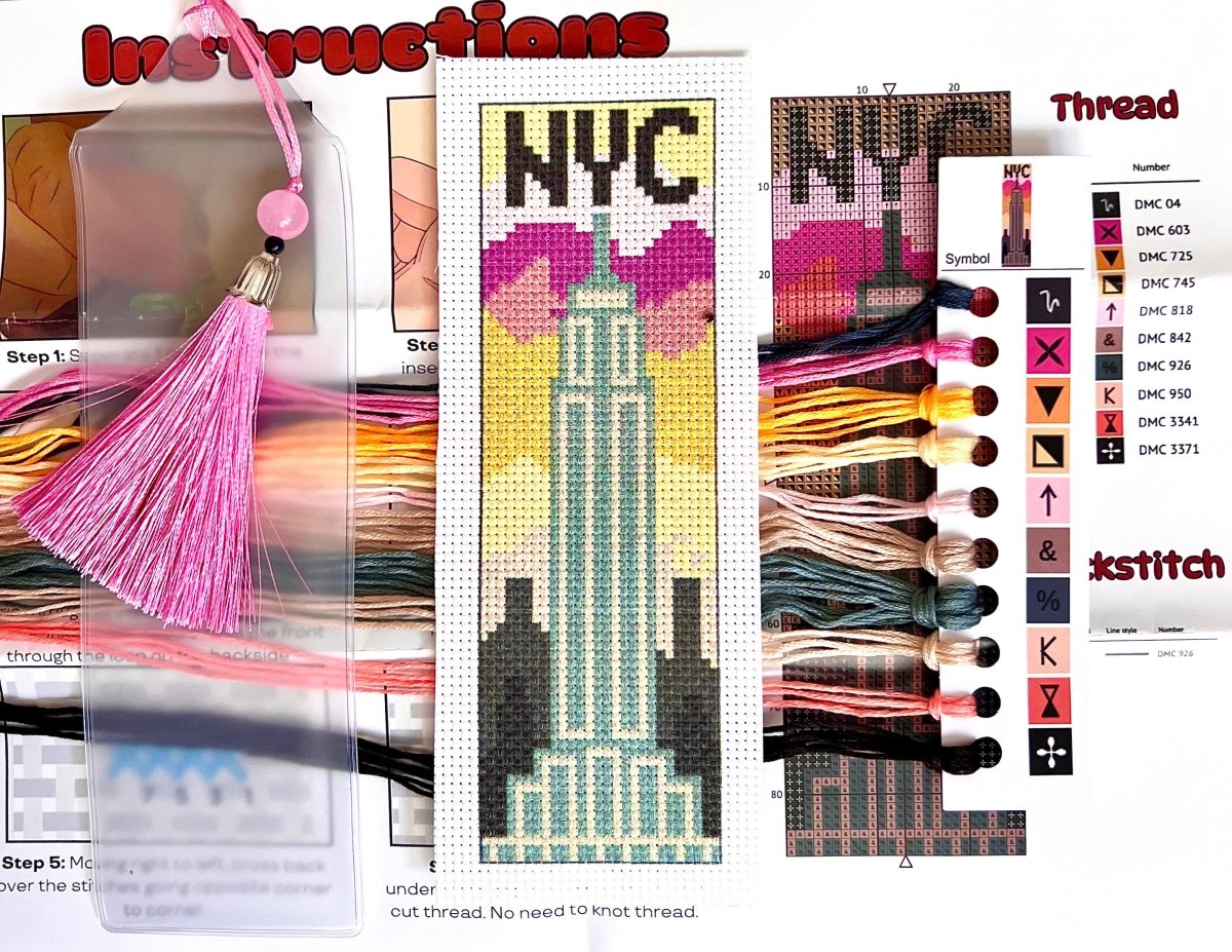 Cross-stitch kit with Empire State Building design, thread selection, and step-by-step instructions.