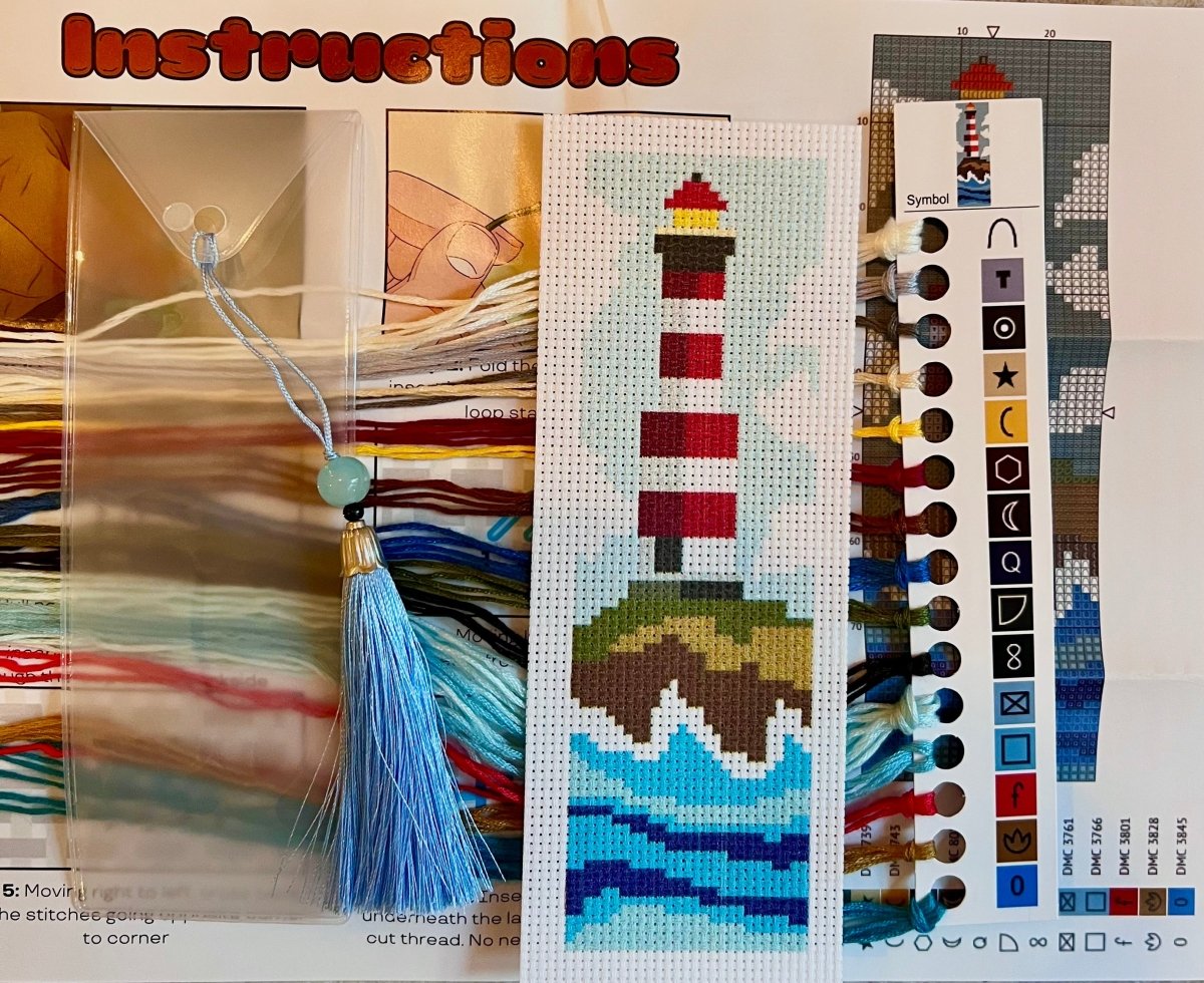 Cross-stitch pattern with a lighthouse design and color chart on a white background.