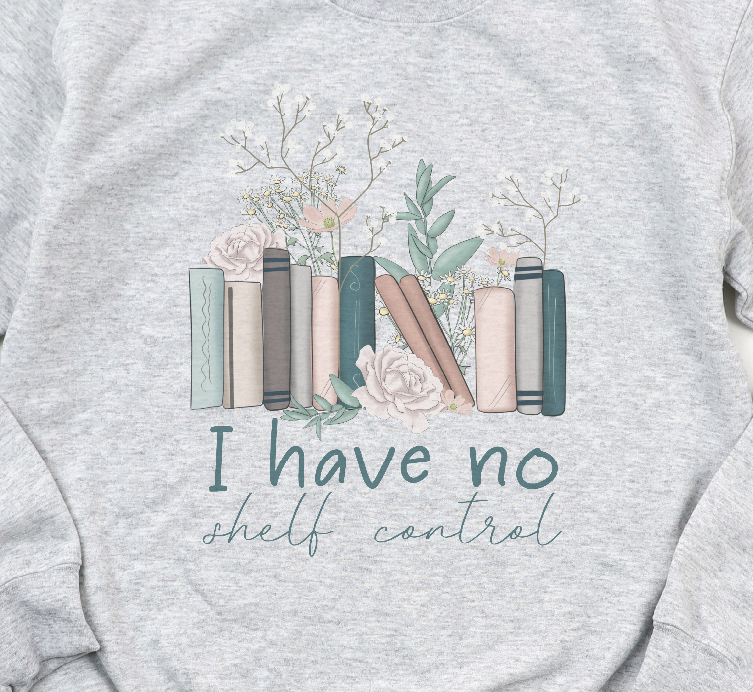 Gray sweatshirt with book and flower design and text 'I have no shelf control' on a plain background