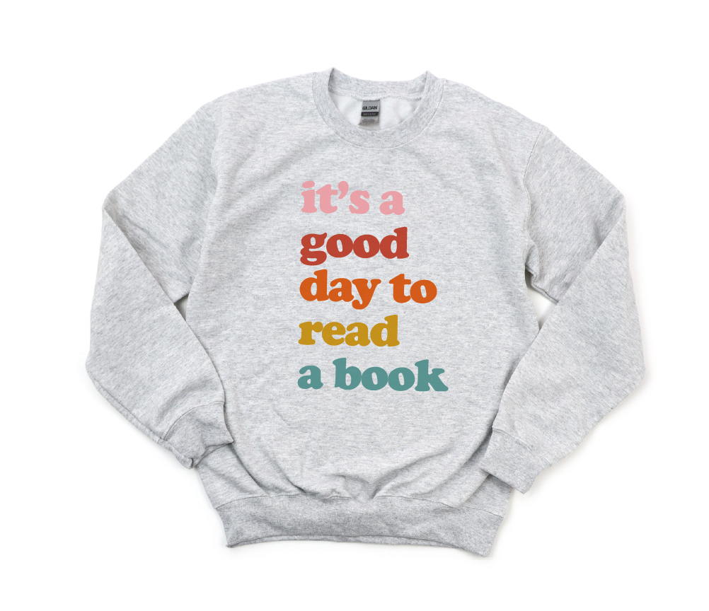 Gray sweatshirt with colorful text 'it's a good day to read a book' on a white background