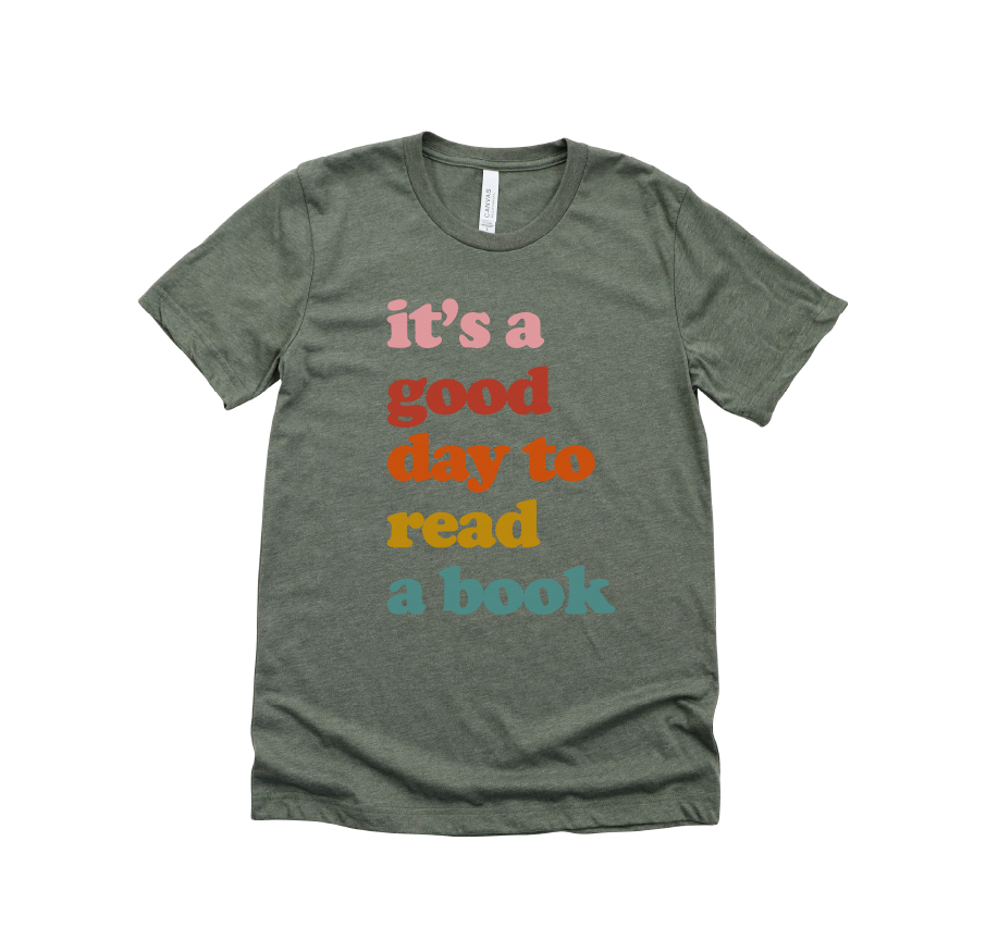Green t-shirt with colorful text 'it's a good day to read a book' on a white background