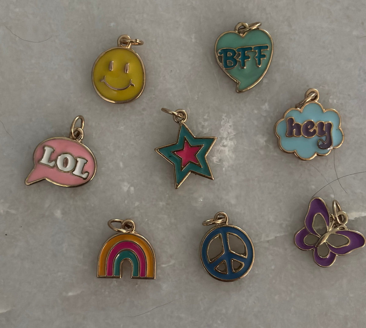 Collection of colorful charms on a gray surface