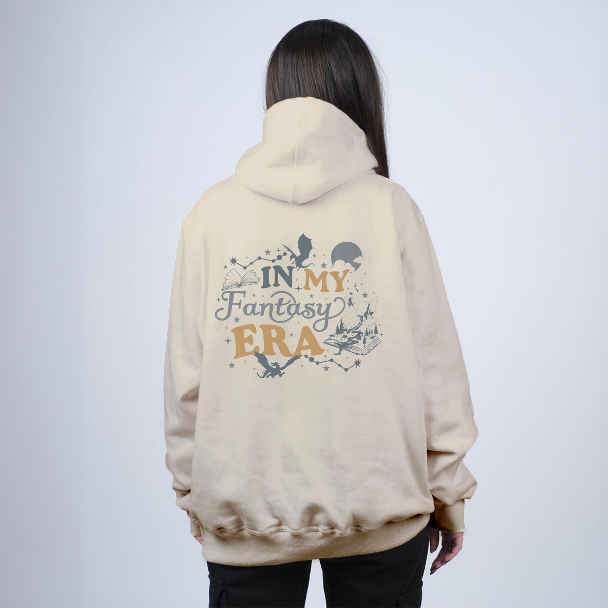 Person wearing a beige hoodie with text and graphics on the back against a light gray background