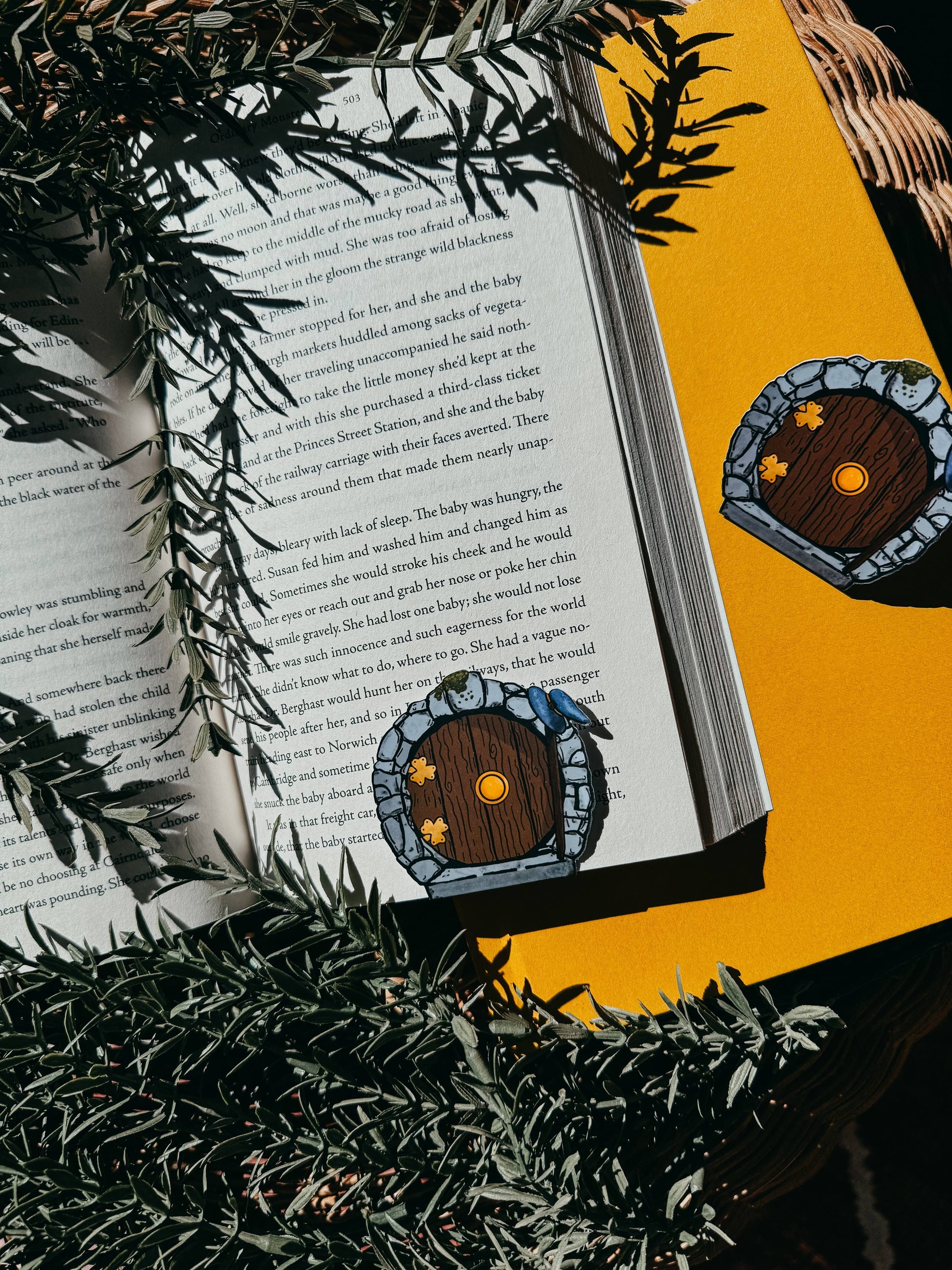 Open book with a fairy door illustration on a yellow background
