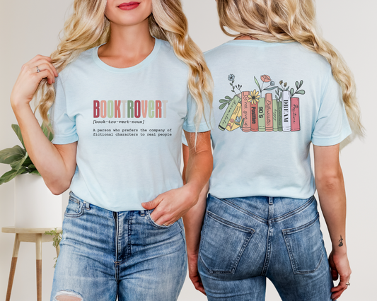 Person wearing a light blue t-shirt with 'Book Rover' text and colorful book design on the back.